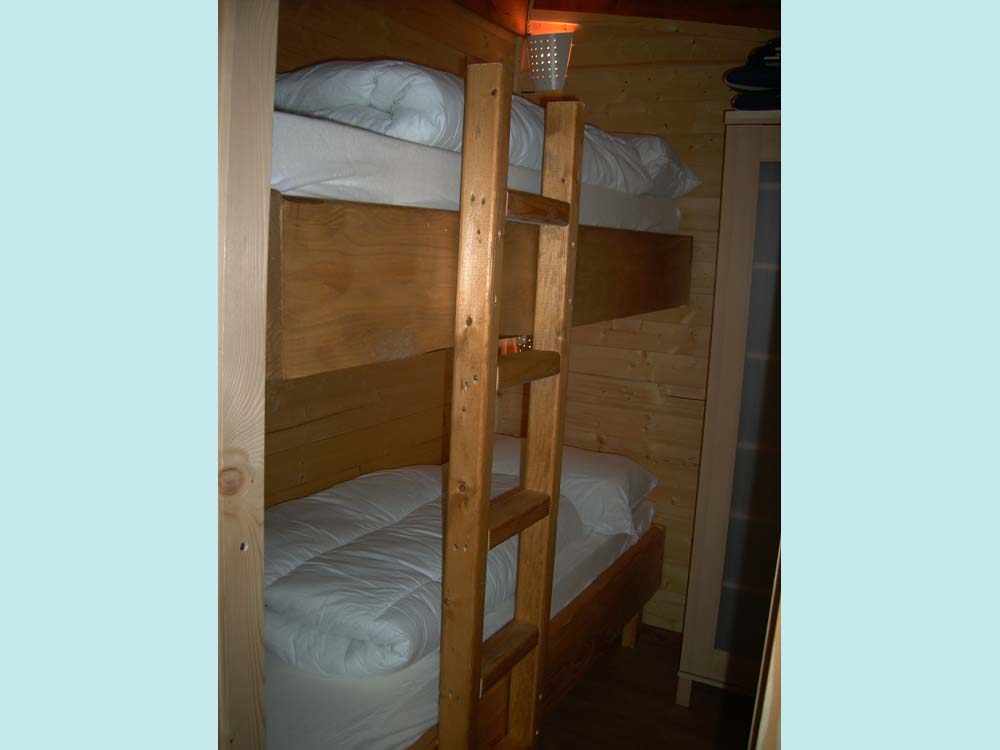 Slaapkamer met stapelbed en gewoon bed